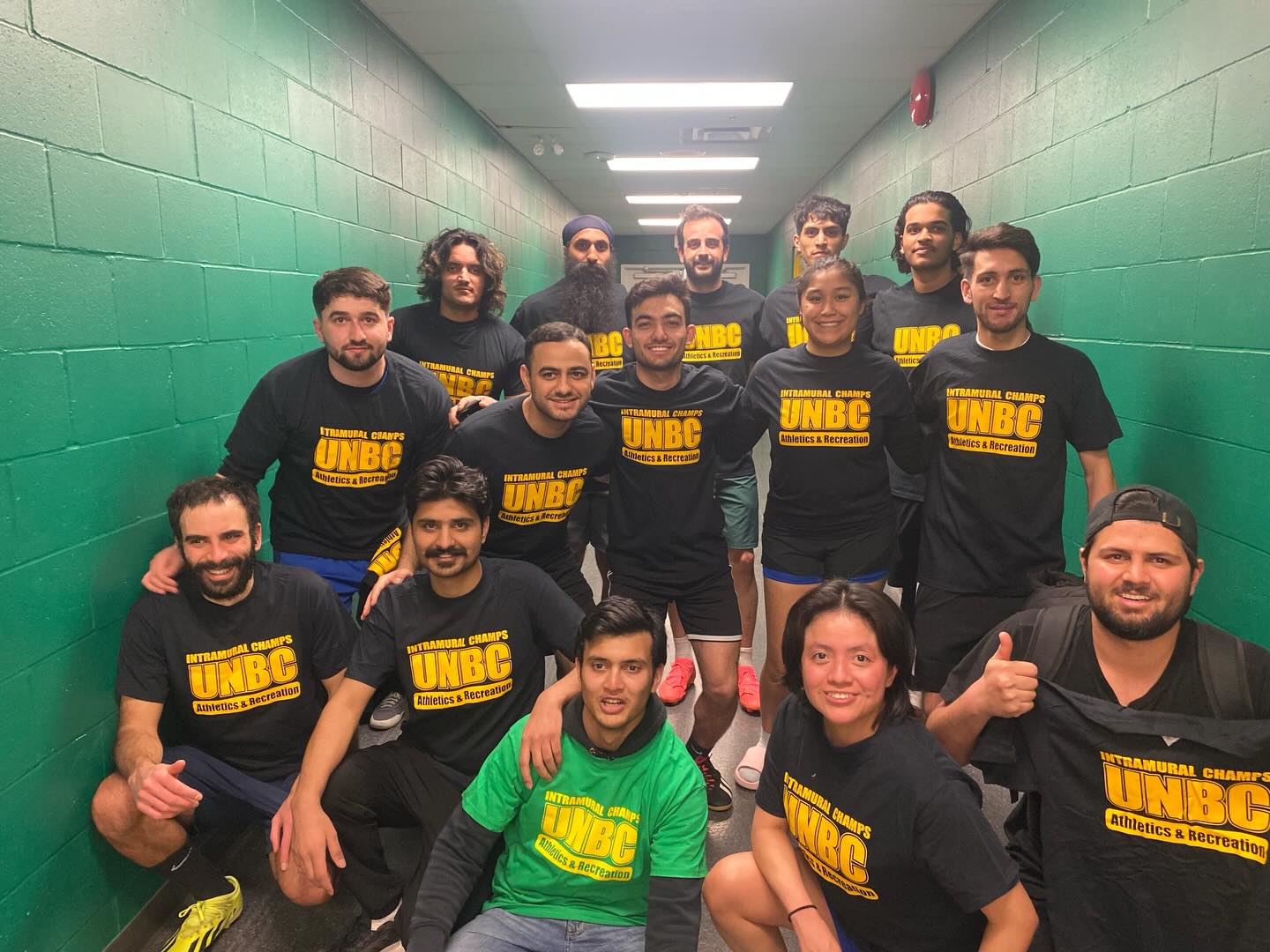 UNBC Intramurals champions posing together after a volleyball title win.